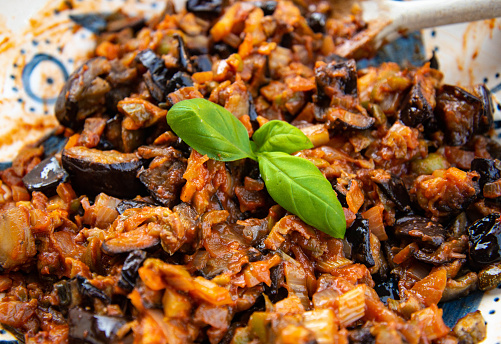 Sicilian caponata salad with basil leaves in bowl