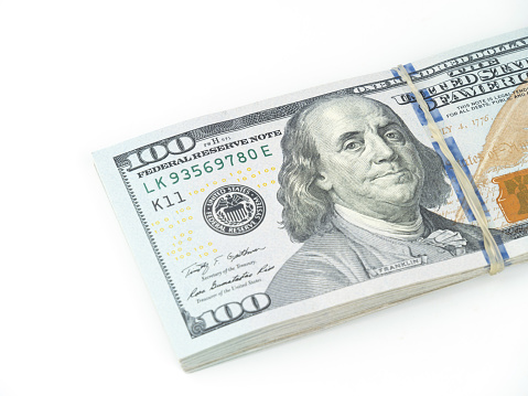 A Roll of U.S Dollar Bills on White Background