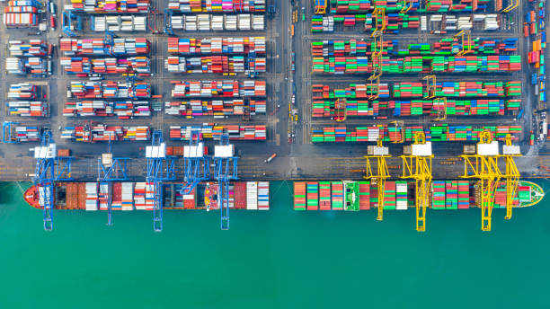 istock Container ship loading and unloading in deep sea port, Aerial top view of business logistic import and  export freight  transportation by container ship in open sea. 1406350266