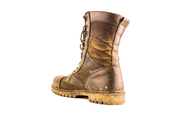 dirty military style light ankle boot isolated on white background - three quarter back view