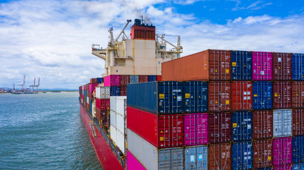 istock Container ship carrying container for business freight import and export, Aerial view container ship arriving in commercial port. 1406350385