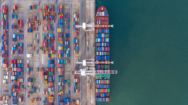 istock Container ship loading and unloading in deep sea port, Aerial top view of business logistic import and  export freight  transportation by container ship in open sea. 1406350400