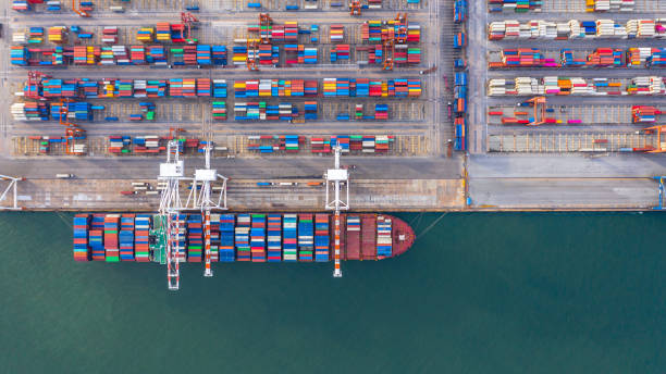 istock Container ship loading and unloading in deep sea port, Aerial top view of business logistic import and  export freight  transportation by container ship in open sea. 1406350413