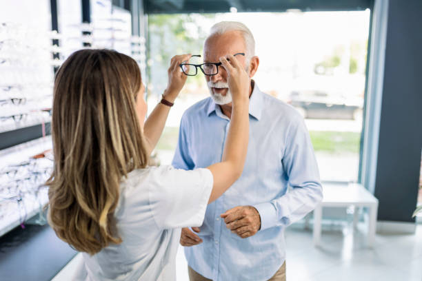istock Young woman with senior customer in optic store 1406351457