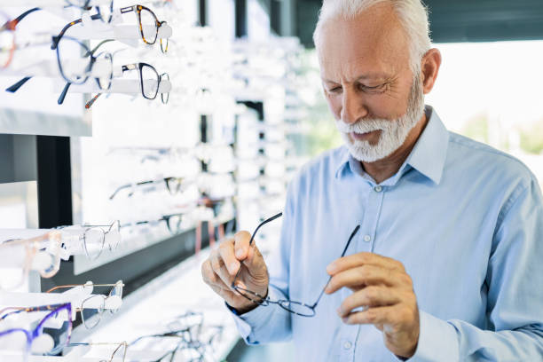 Senior man trying on eyeglasses