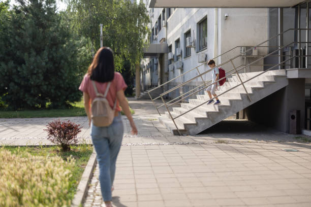 istock Mother coming for son at school 1406352207