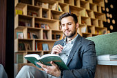 istock Smiling young man reading without glasses 1406352659