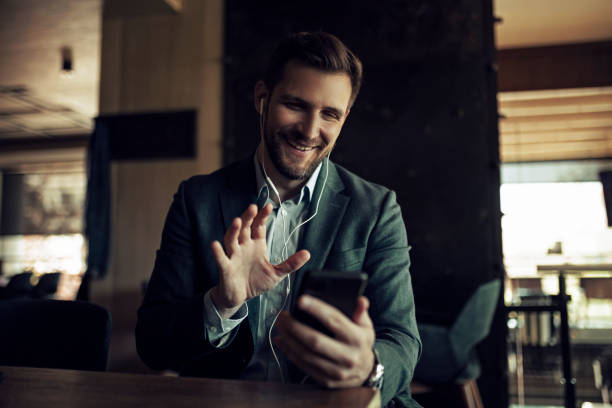 istock Businessman on a coffee break using phone for video call 1406352697