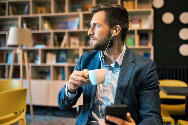 istock Wearing headphones looking through window 1406352704