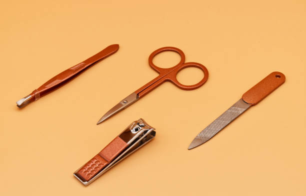 istock Set for cutting nails. Tools of a manicure set on orange background 1406355214