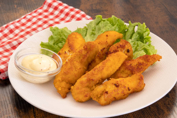 istock fried chicken with sauce and lettuce on a plate 1406356533