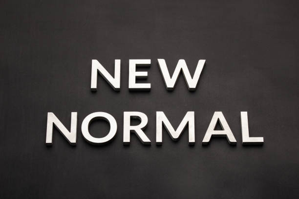 istock Words new normal on black surface in flat lay perspective 1406358318