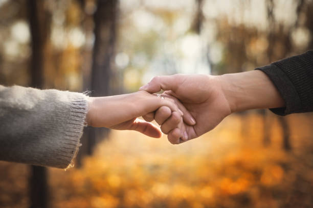 istock Close-up of a couple in love holding hands while walking. Selective focus 1406360417
