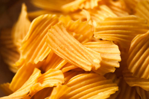 close-up, golden yellow, sweet potato chips, white background stock photo