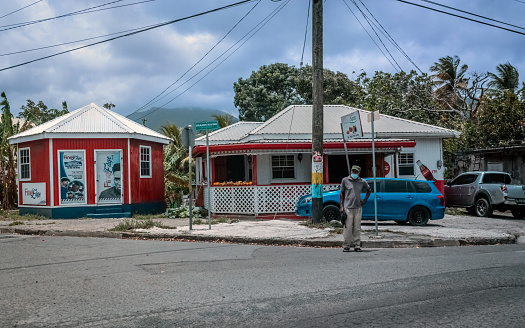 Dennery, SAINT LUCIA - April 30, 2022: -  The Ideal Spot market with a masked man in Dennery, St Lucia.