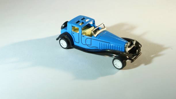 istock classic blue toy car isolated on white background. 1406365115