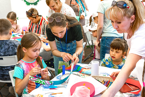 Chelyabinsk Russia June 25 2022 a master class on making paper decorative ornaments is being held at the children's holiday