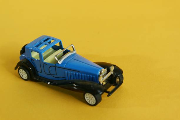 istock Classic toy car isolated yellow background. 1406365387