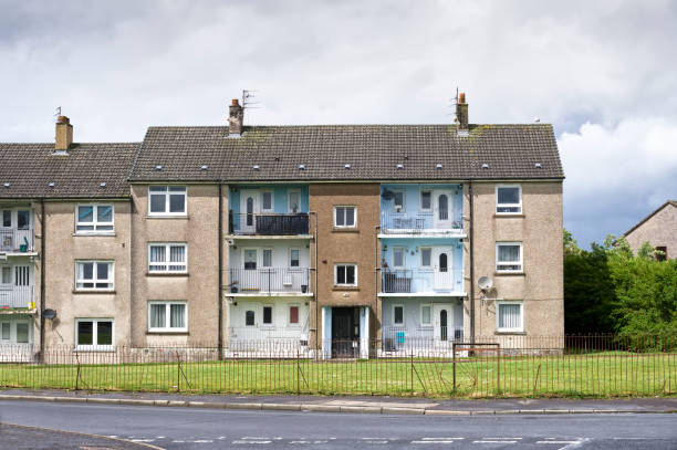 Derelict council house in poor housing estate slum with many social welfare issues in Port Glasgow Derelict council house in poor housing estate slum with many social welfare issues in Port Glasgow uk council flat stock pictures, royalty-free photos & images