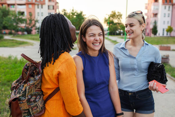 istock Three multiethnic friends in the city park 1406369121