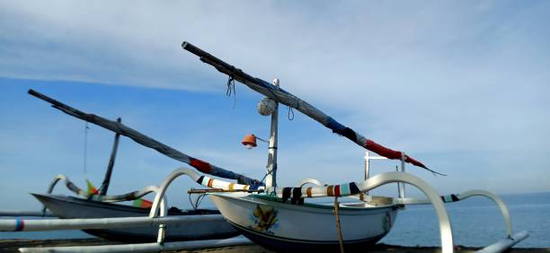 istock White fishing boat on the beach 1406370424