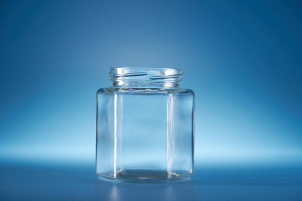 istock empty glass jar without lid against blue background 1406370889