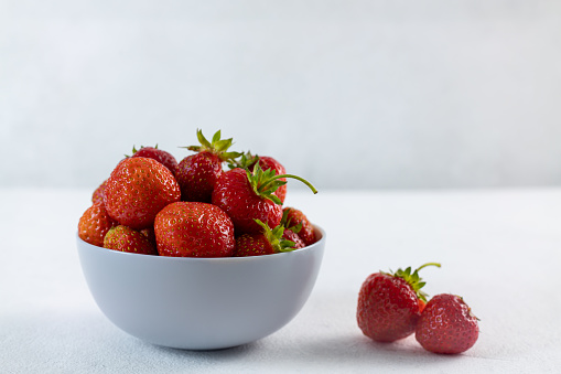 Ripe strawberries on a light background, space for copying, close-up
