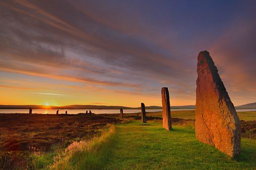 Summer sunrise at the Ring of Brodgar in the Heart of Neolithic Orkney with the sun just breaking over the Loch of Harray.  The stone circle dates back to between 2500BC to 2000BC and is part of the wider 'Neolithic Heart of Orkney' comprising Skara Brae, the Stones of Stenness, Maeshowe and the Barnhouse Stone.