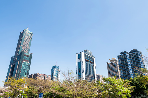 Kaohsiung, Taiwan- March 11, 2022: Low angle view of metropolis buildings such as the 85 Sky Tower in Kaohsiung, Taiwan.