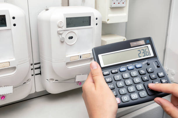 istock Man with calculator and energy electric meter 1406373875