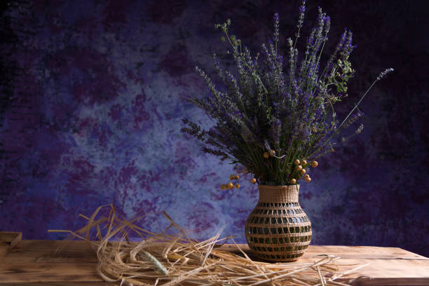 lavender and wheat still life still life with a vase with lavender on a wooden table and surrounded by ears of wheat in front of a purple background alternative for germany photos stock pictures, royalty-free photos & images