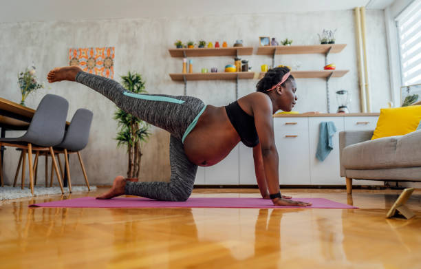 istock Pregnant woman training at home 1406376010