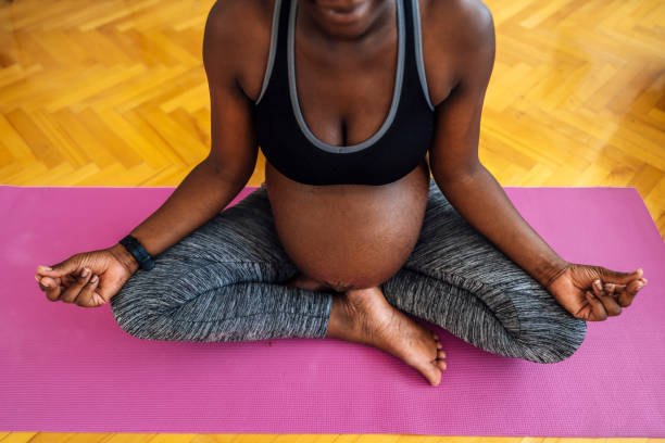 istock Pregnant woman meditating at home 1406376265
