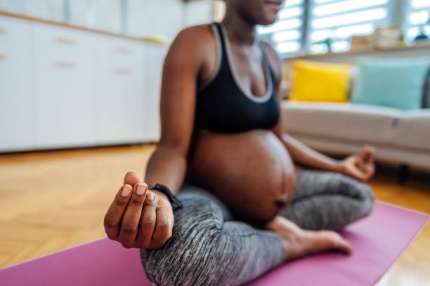 istock Pregnant woman meditating at home 1406376277