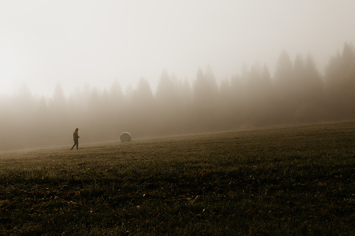 Walking man on a misty morning at a rural place in Bhutan.
