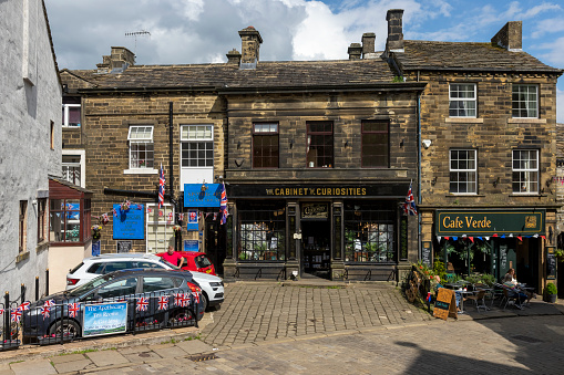 This is historic Haworth, Yorkshire, England, UK, home of the Bronte sisters.  The village is bedecked in bunting and union flags as it celebrates the Platinum Jubilee of Queen Elizabeth II.