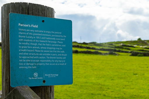 Sign giving the history of the Parson's Field Meadow near the Bronte parsonage in Haworth, Yorkshire, England, UK.