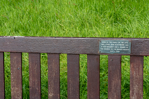 Sign on a memorial bench in Parson's Field Meadow near the Bronte parsonage in Haworth, Yorkshire, England, UK.