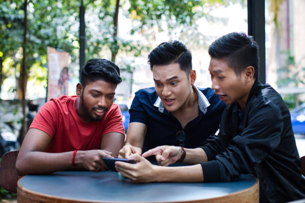 istock Friends watching live stream sport on a smartphone 1406383724