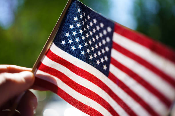 istock Holding Miniature American Flag 1406383882
