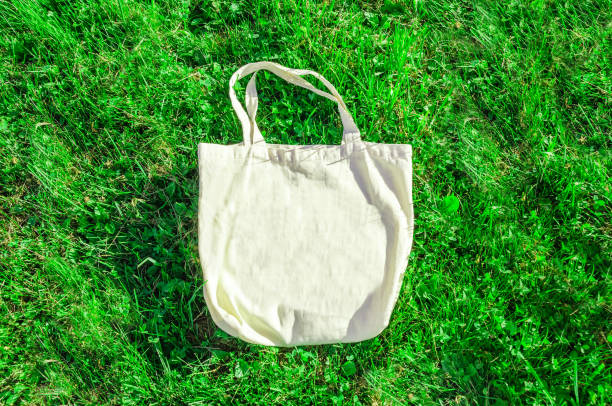 istock cotton shopping bag on green grass background. Zero waste, no plastic, eco friendly. template 1406392739