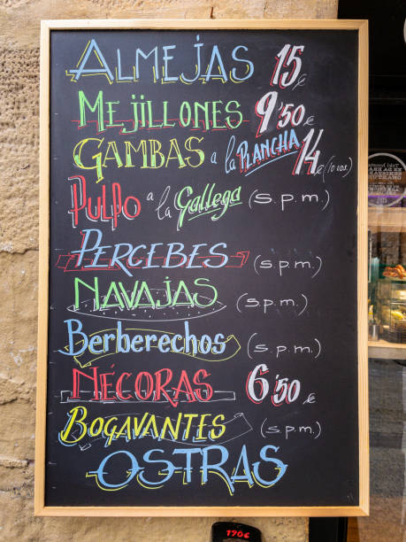 A blackboard menu offering typical Spanish seafood. San Sebastian, Spain - June 23, 2022. A blackboard menu offering typical Spanish seafood. razor clam stock pictures, royalty-free photos & images