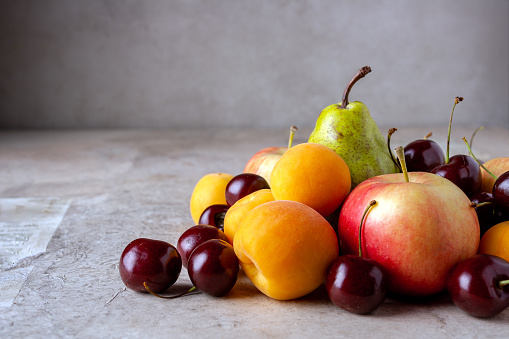 ripe fruits on a beige background, selective focus, copy space
