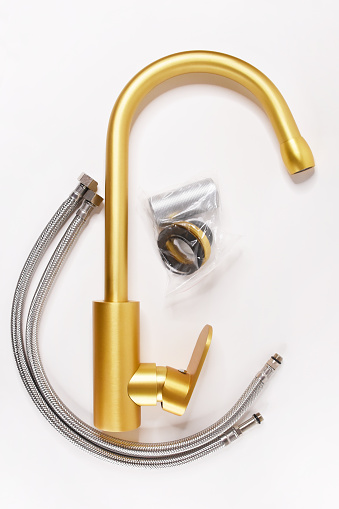Golden faucet set with pipeline on the white background