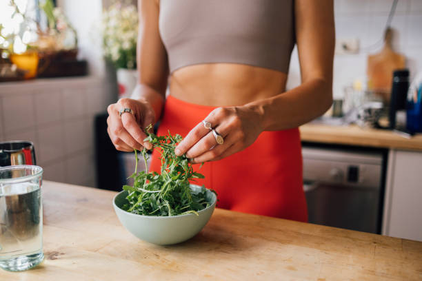 istock Anonymous Woman Preparing Her Meal 1406403615
