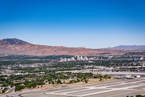 A shot of Reno-Tahoe International Airport with downtown Reno in the background, taken from the top of Rattlesnake Mountain.