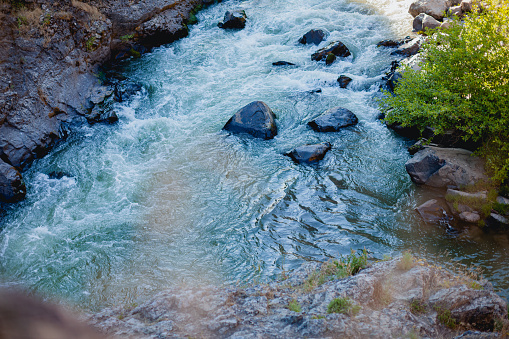 Close-up of water flowing through river rocks