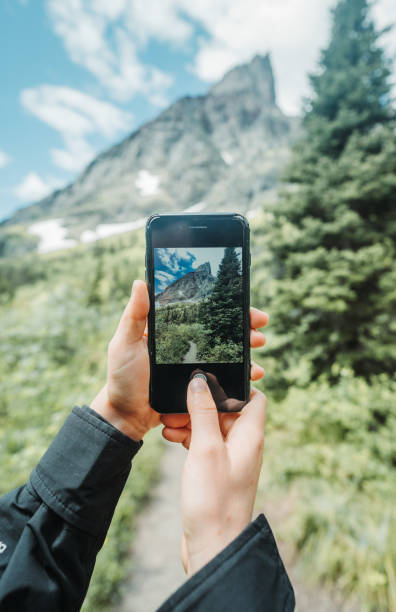 istock Taking photo with phone on hike of mountain 1406409737