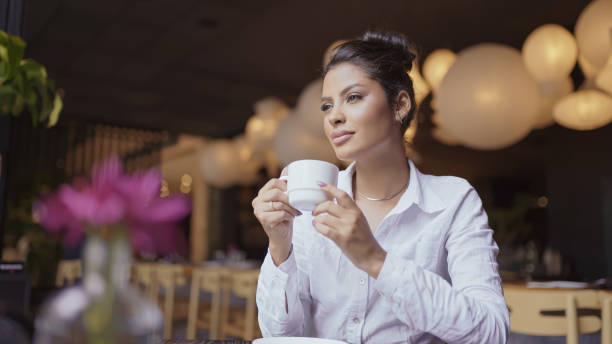 istock Latin woman in a cafe drinking coffee. 1406413850