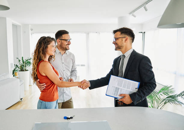 couple man deal woman contract business agent agreement estate investment consultant meeting document keys Real estate agent with couple shaking hands closing a deal lease agreement stock pictures, royalty-free photos & images